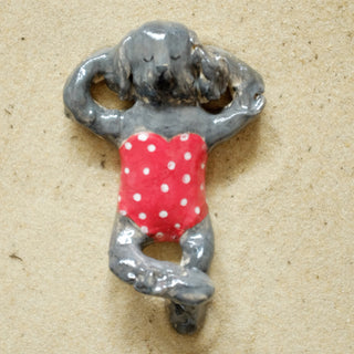 Fluffy grey dog in red Ceramic Figure