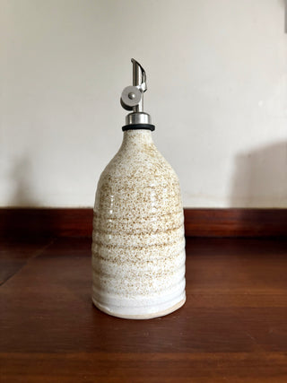 Small speckled white oil bottle