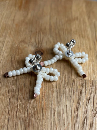 White pearl bow studded earrings