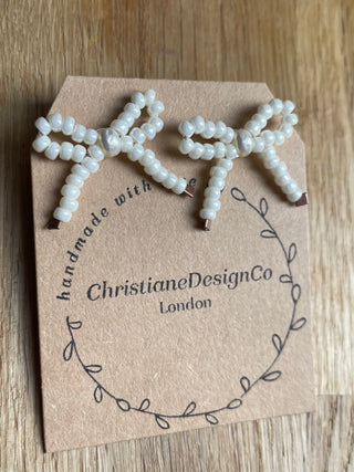 White pearl bow studded earrings